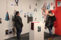 Ivanna and Mikenna experience an installation of photos, writings, and artifacts from Nepal.